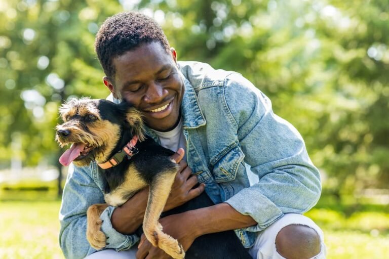 Man hugging his dog in a park